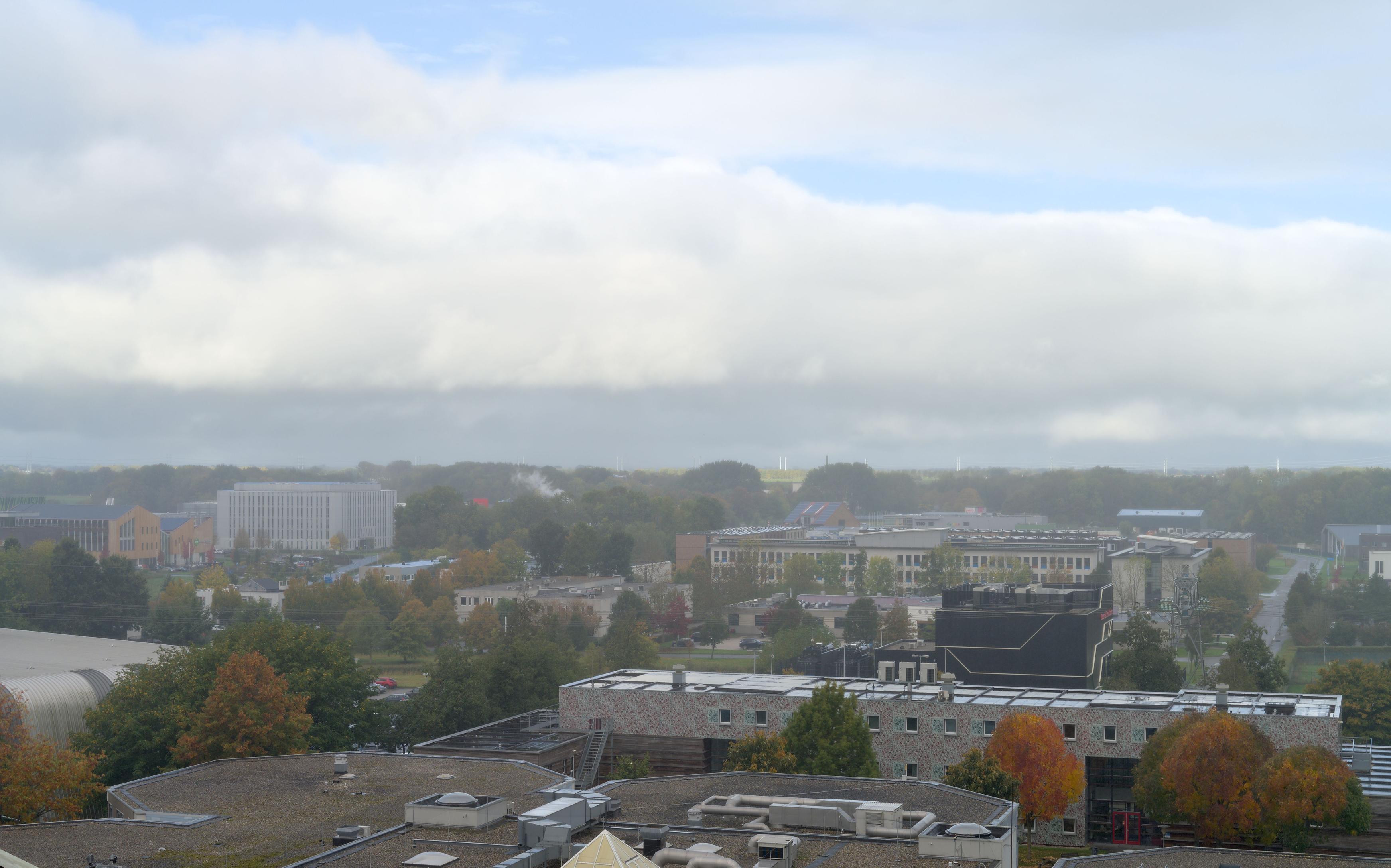 Slight hazy fog covers the campus and we see some sun striking the North-Groningen land in the distance.